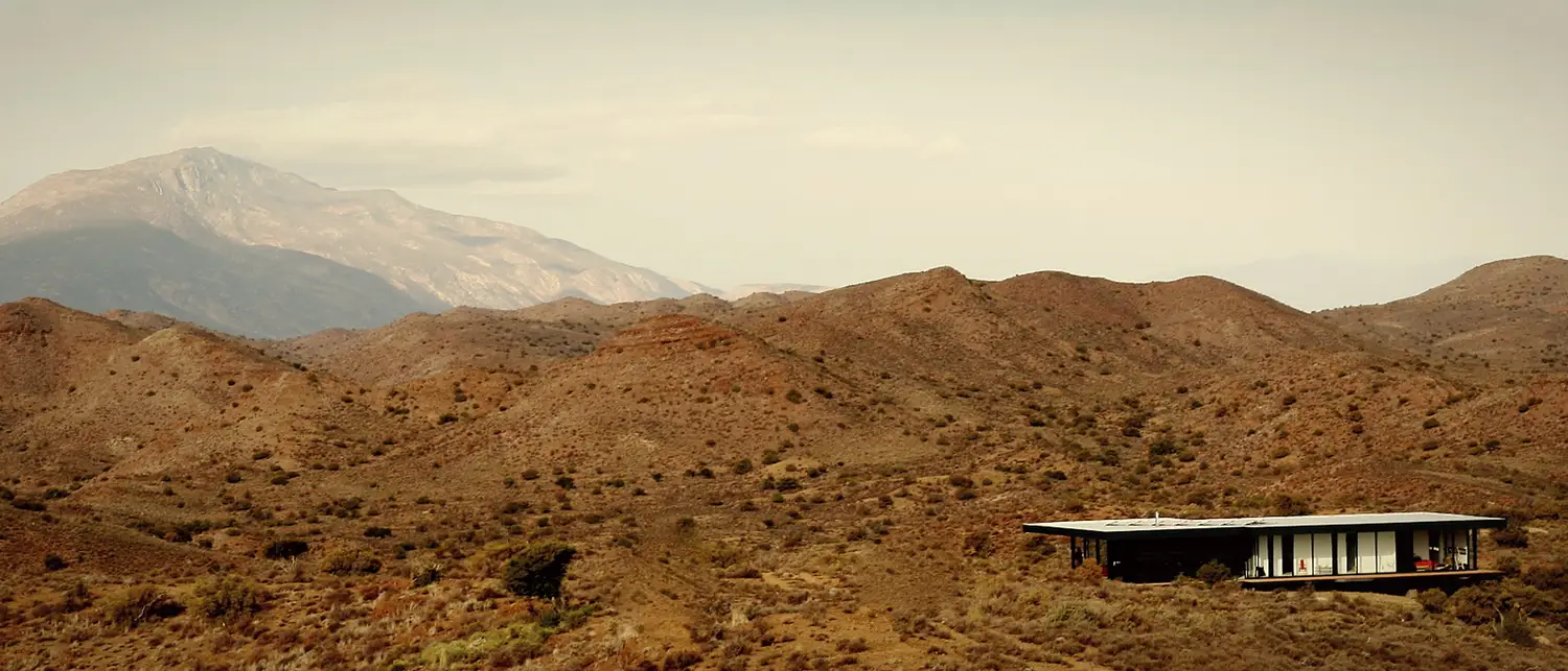 North elevation · the building reading against the koppies and the mountain beyond