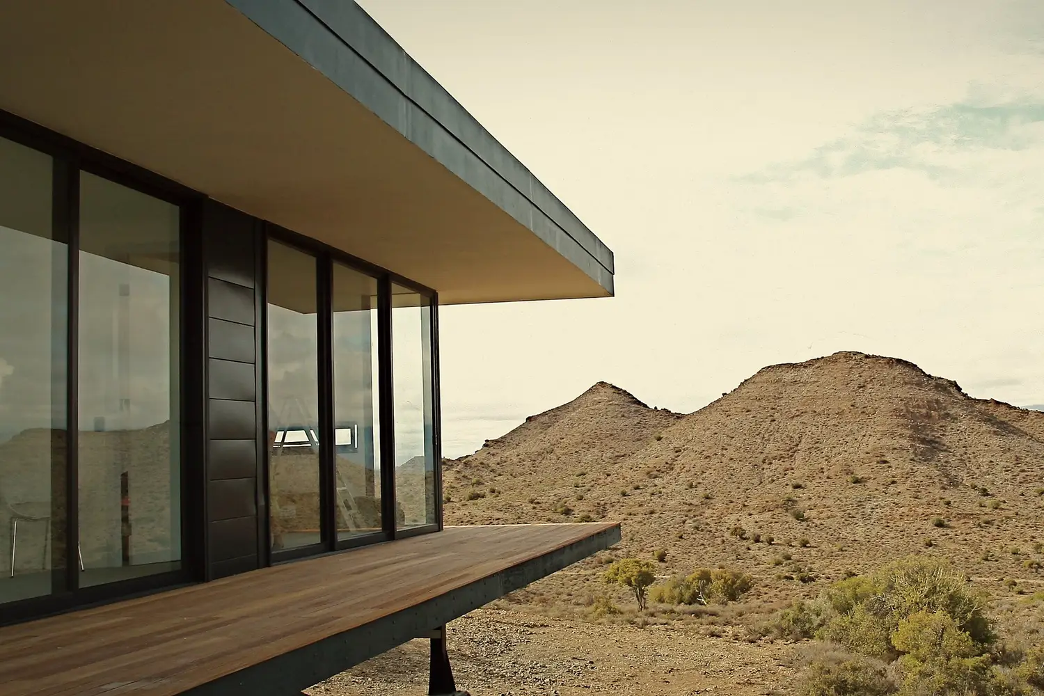 The cantilevered deck close-up, looking out to the hillside